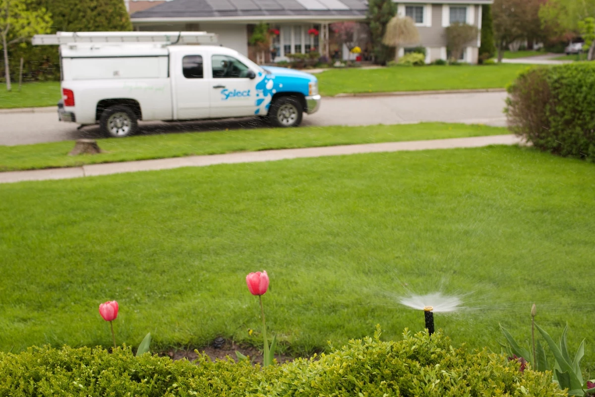 Select Sprinkler truck by the lawn